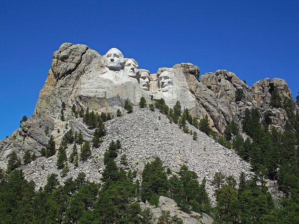 Mount Rushmore National Monument presented to include surrounding background.